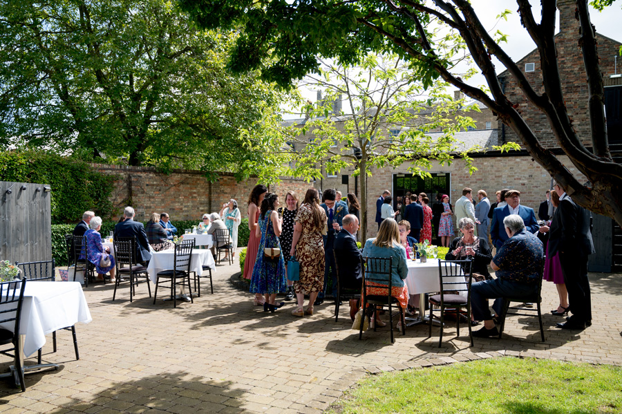 Wedding drinks reception in the courtyard at Poets House, Ely wedding venue