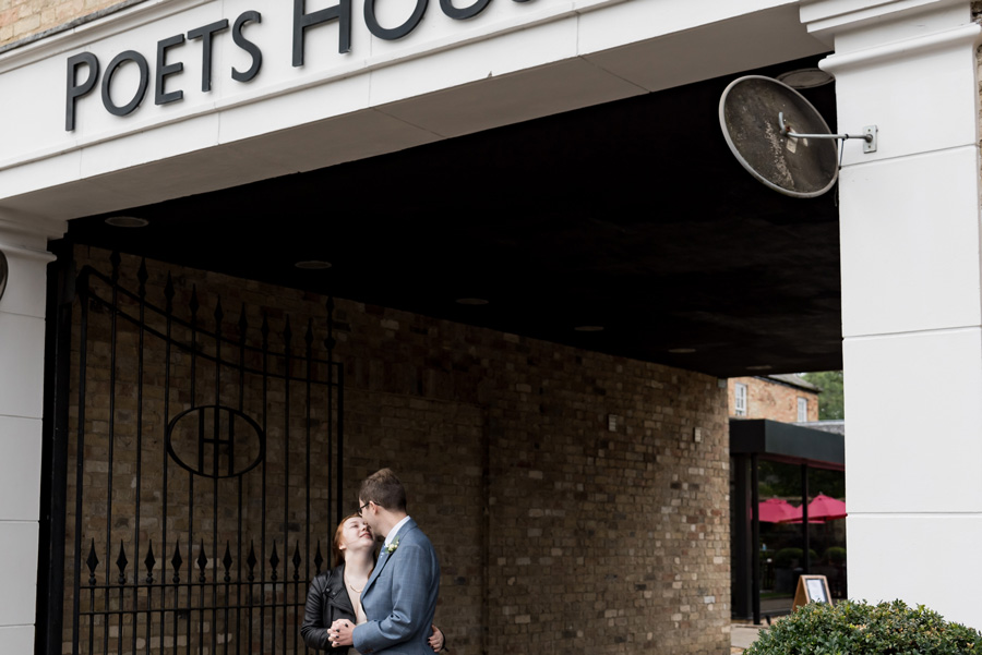 Couple embracing outside Poets House in Ely during a wedding reception