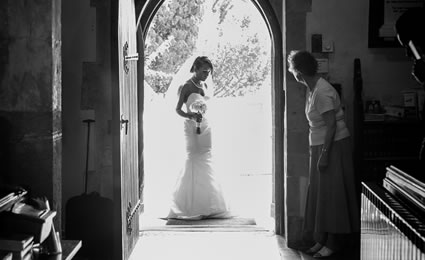 Caught in the moment: Bride in doorway photo
