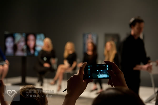 Looking at panel through the screen of another audience member
