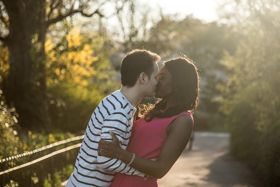 Couple kissing in park at sunset