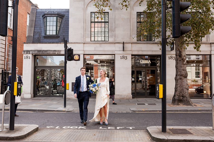 Couple crossing the road after getting married