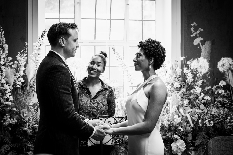Intimate Town Hall wedding ceremony with couple listening