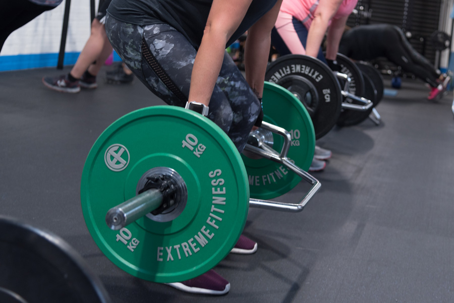 Women lifting weights during gym session