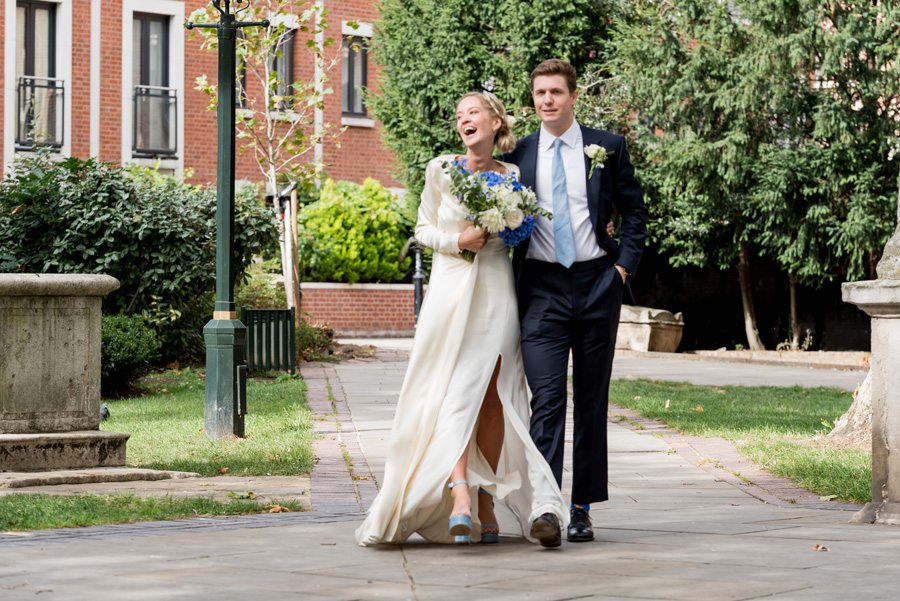 Couple laughing while walking through park