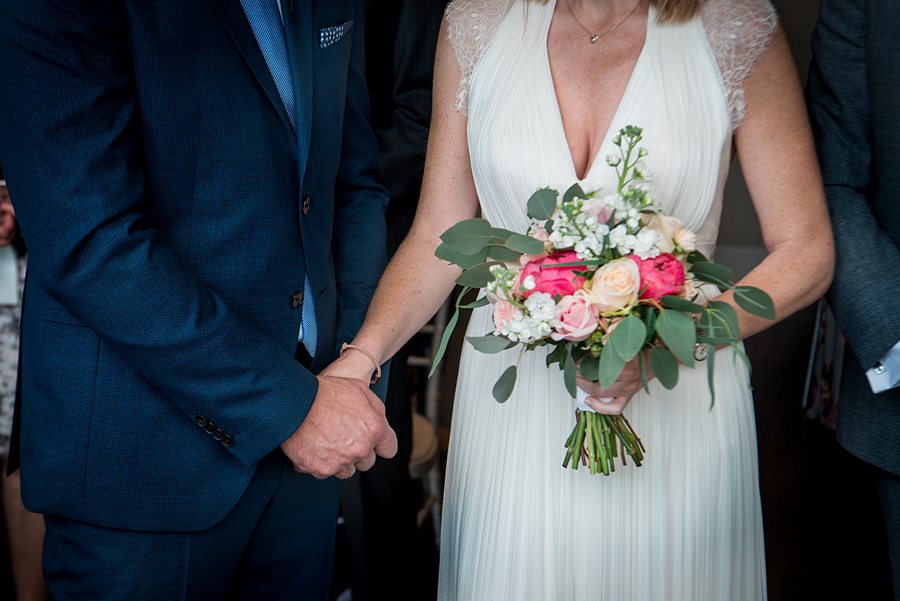 Couple holding hands at the altar