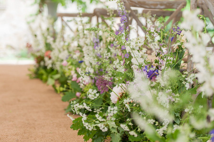 Flowers in aisle at wedding ceremony