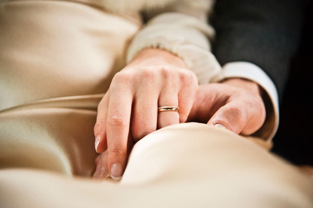 Wedding couple holding hands