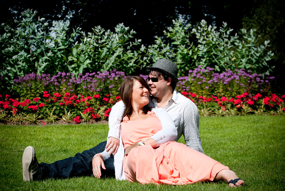 Couple lounging on the grass in park