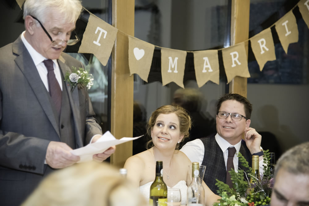 Couple listening to father of the bride speech