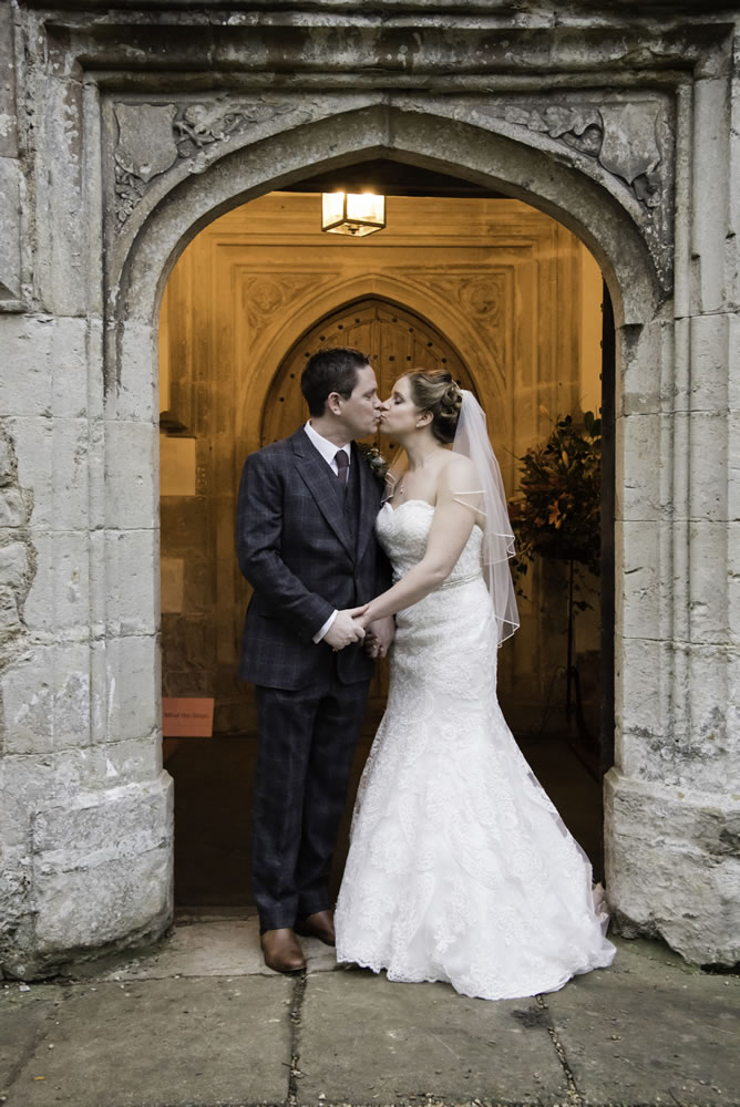 Couple kissing outside church
