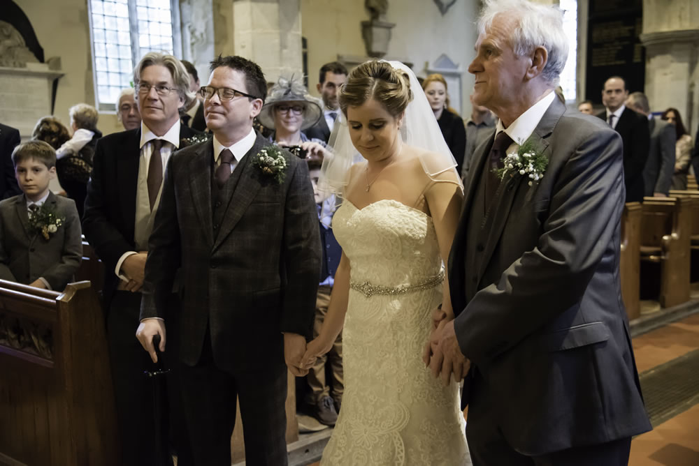 Bride holding father and groom&rsquo;s hands
