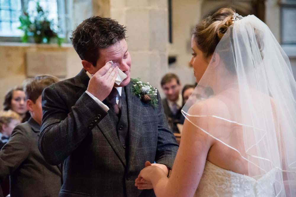 Groom wiping away tears