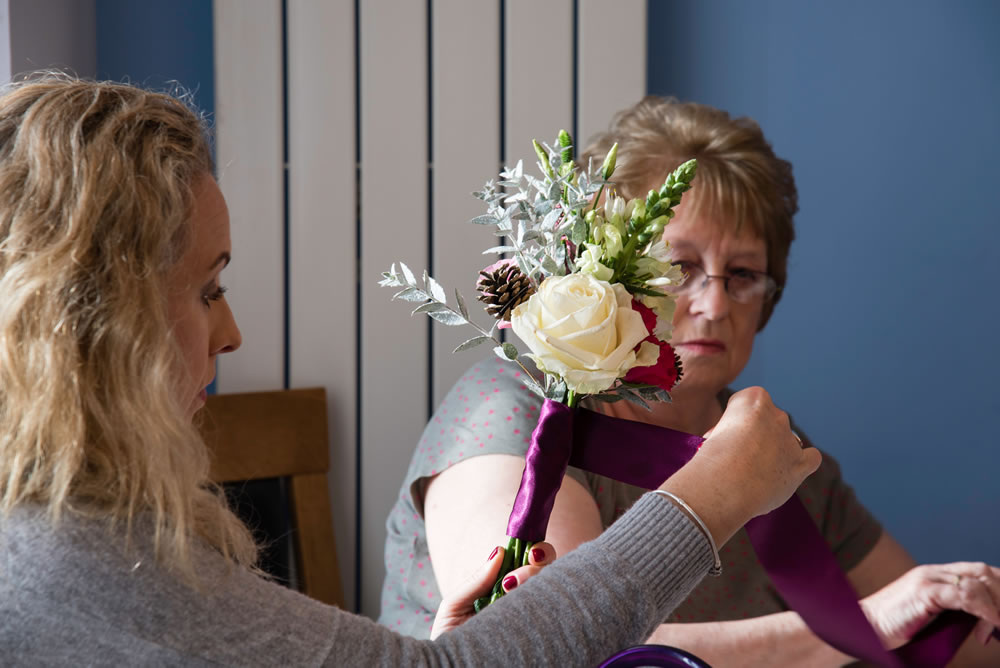Bridesmaid preparing wedding flowers
