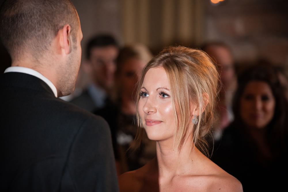 Bride looking at the groom while saying her vows