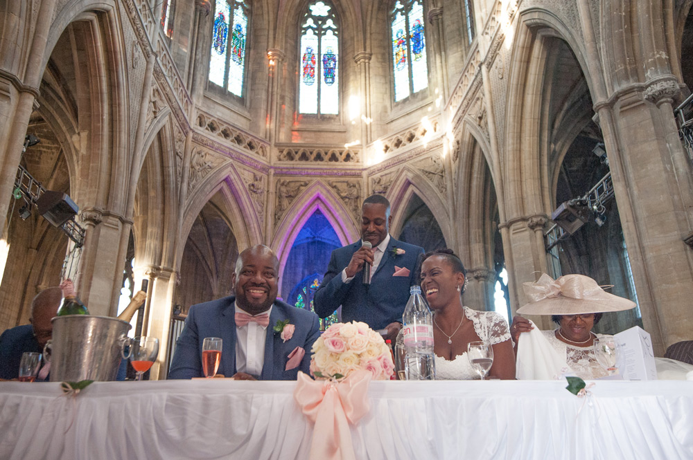 The best man stood behind bride and groom during his speech