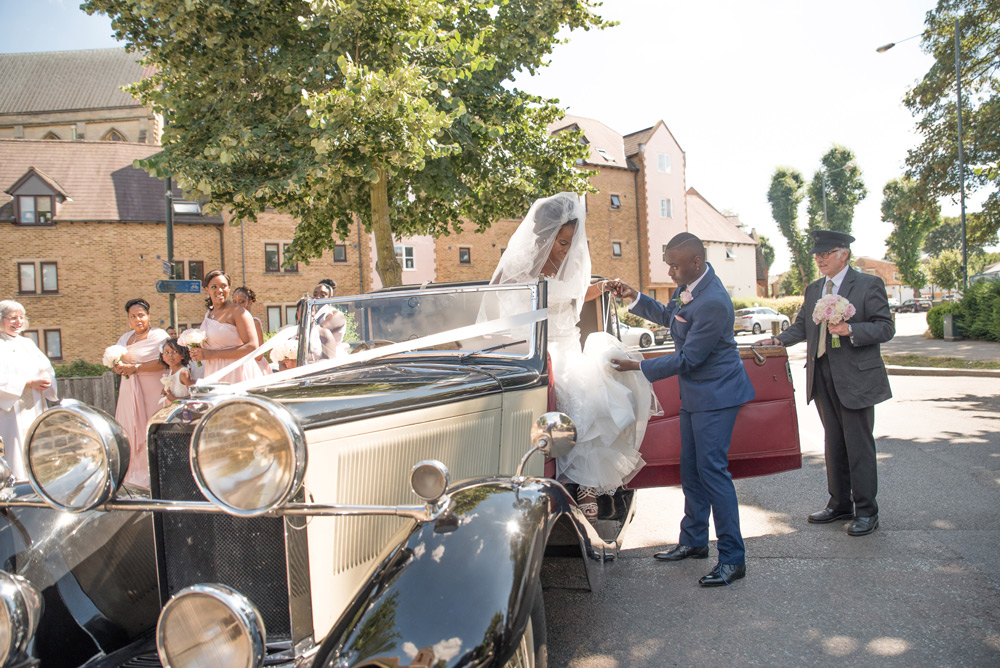 Bride stepping out of the wedding car