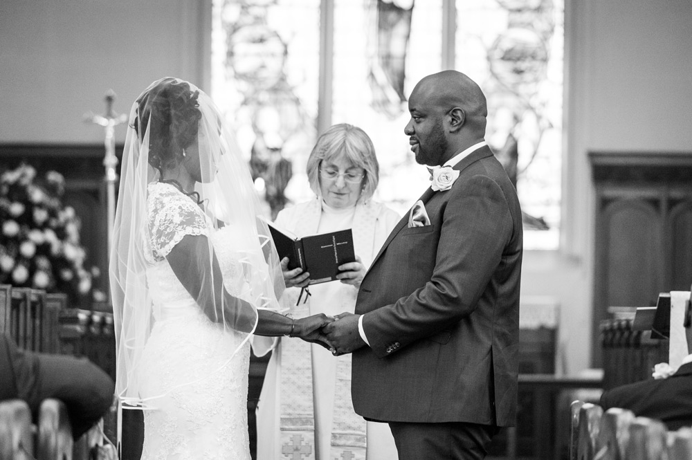 Bride and groom holding hands during ceremony