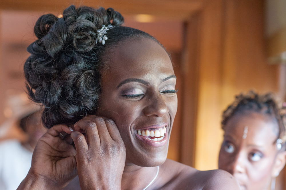 Bride putting on her earring
