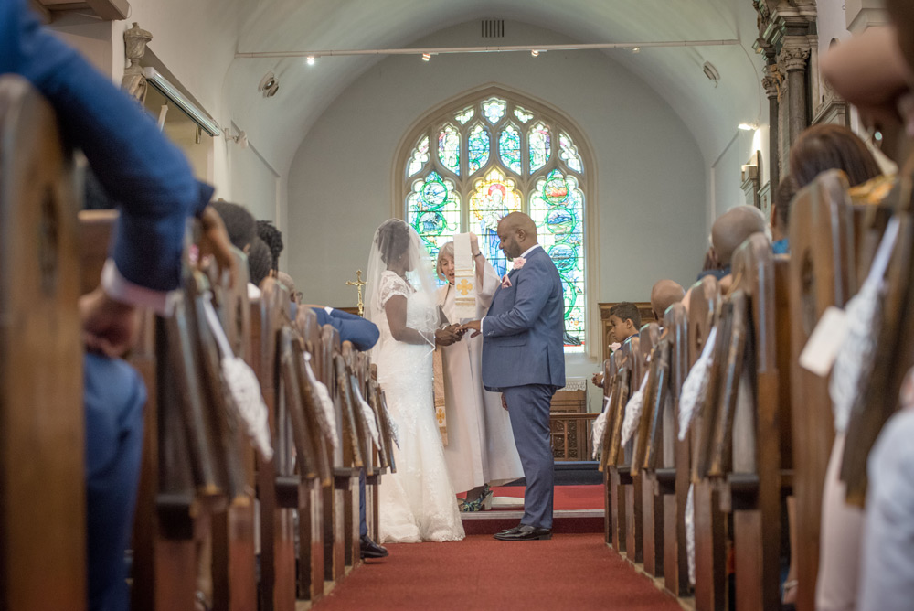 Couple singing at the altar