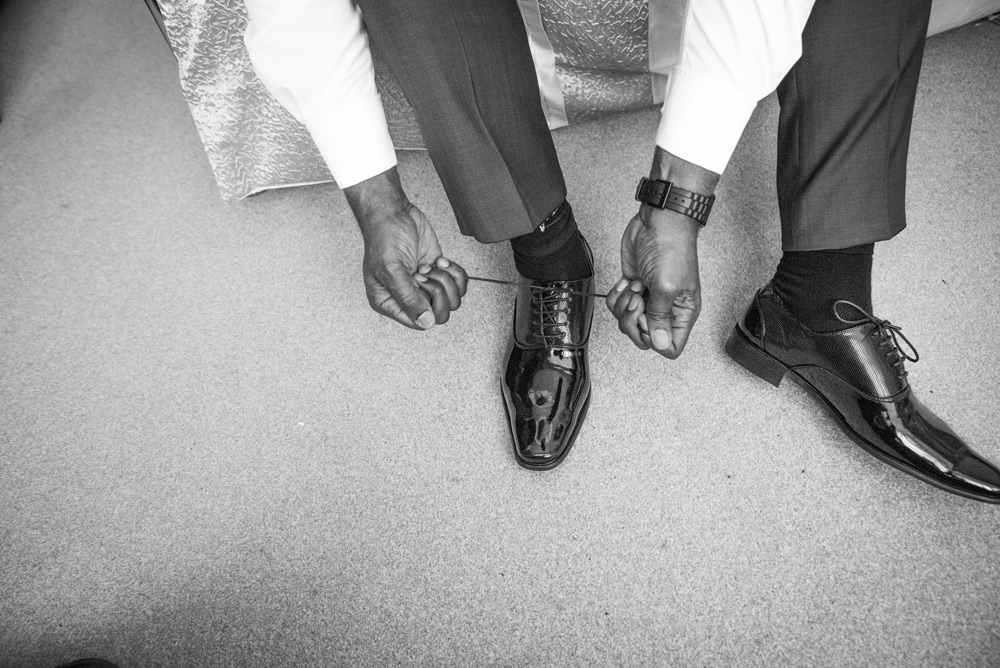 Groom doing up his shoes