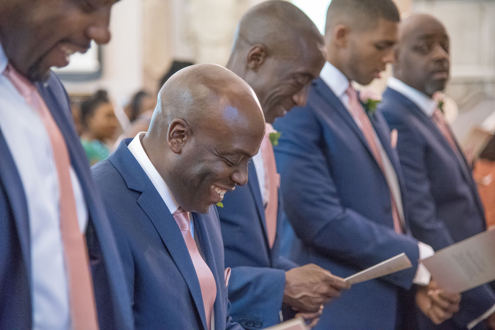 Groomsmen laughing during service