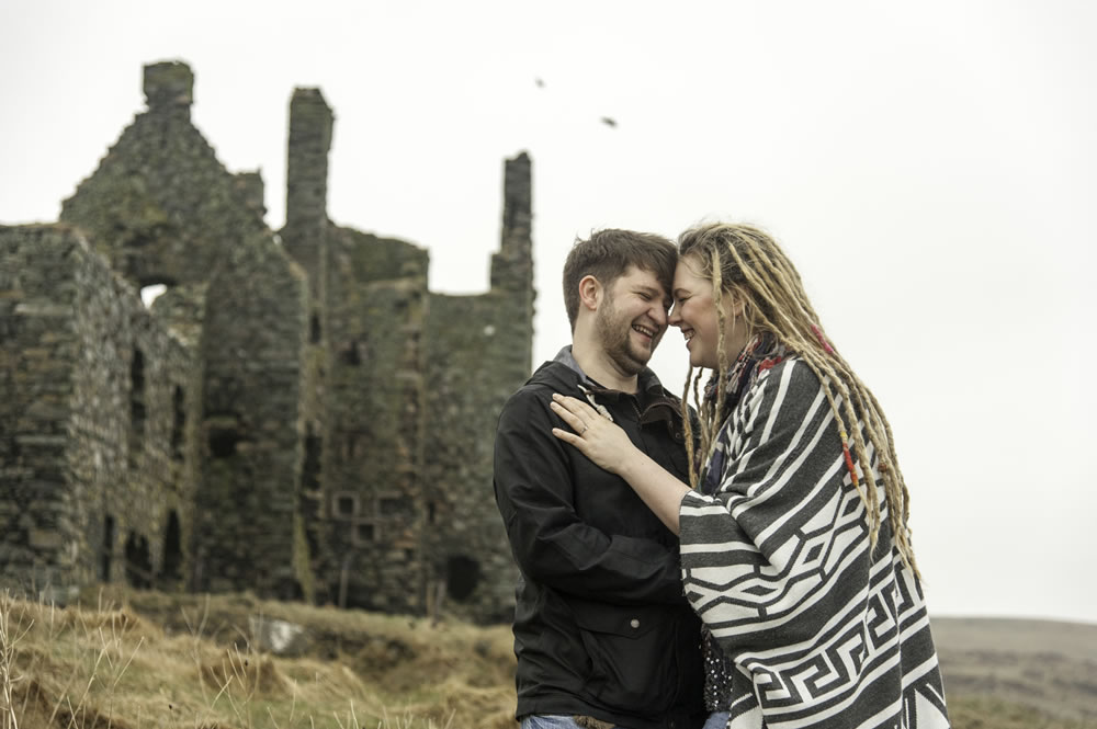 Couple laughing next to castle ruins