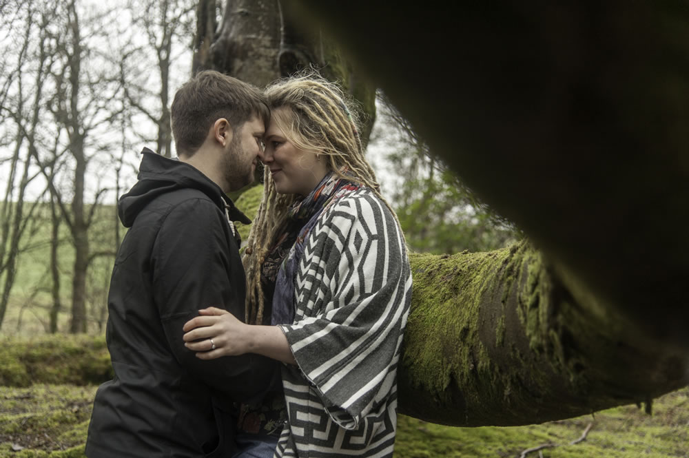 Couple hugging in forest