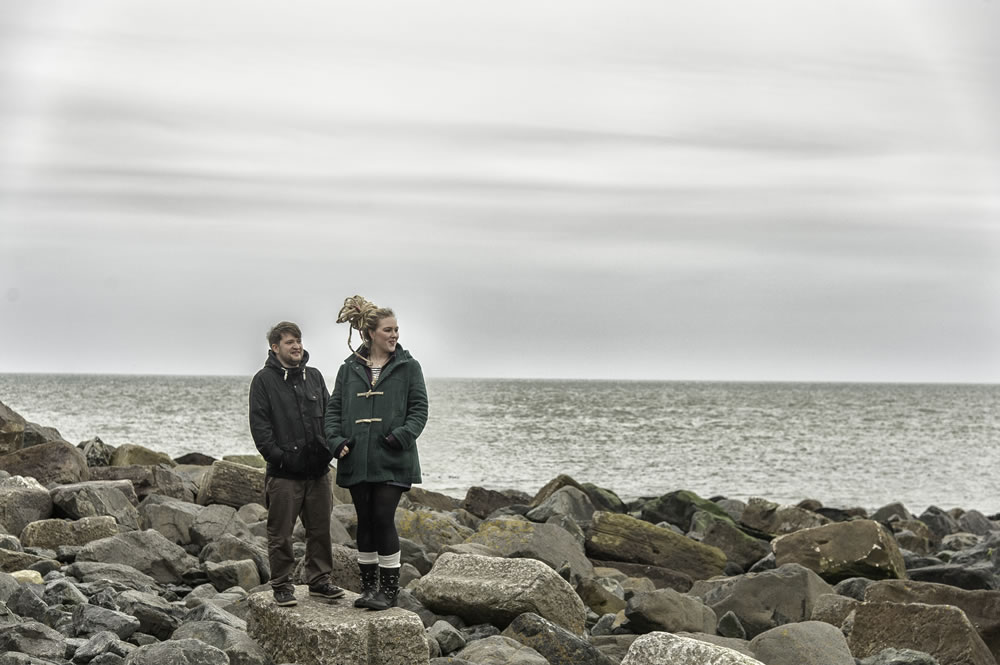 Couple stood on rocks on the beach