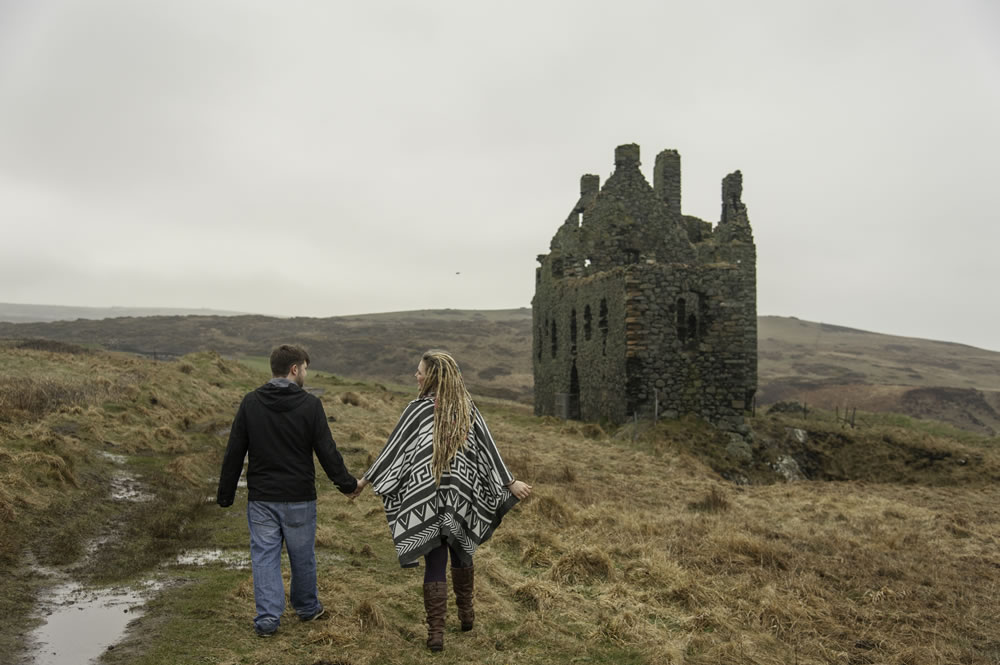 Couple walking towards castle ruins
