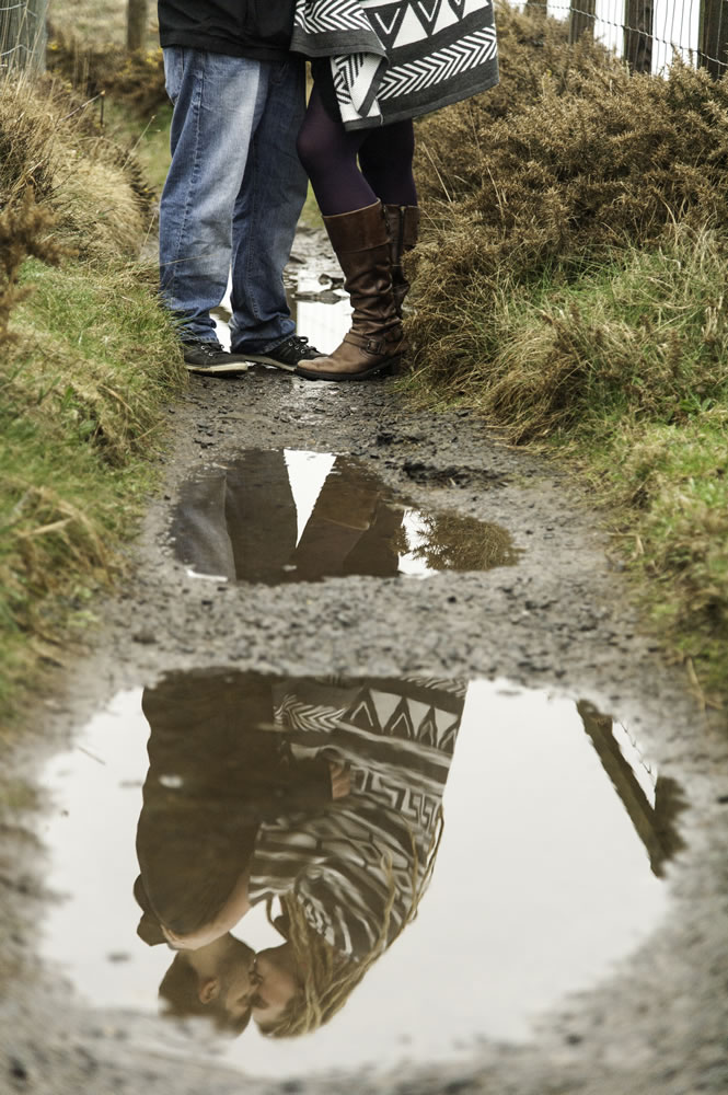 Reflection of couple kissing