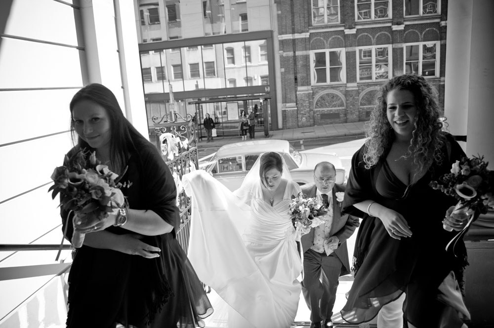 Bridal party climbing stairs into church