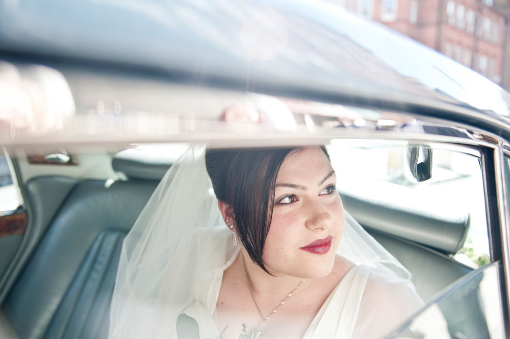 Bride looking out of car window