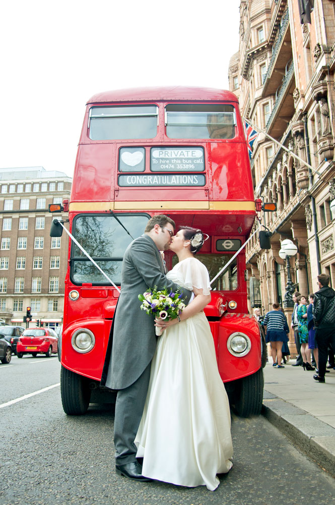 Couple kissing in front of London bus