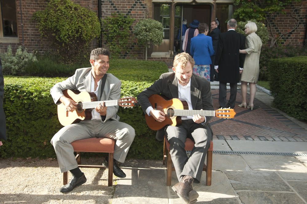 Duo playing as guests mingle