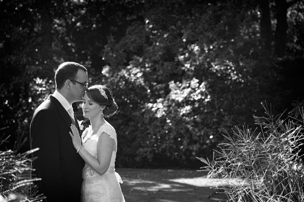 Couple hugging in the gardens of Warren House