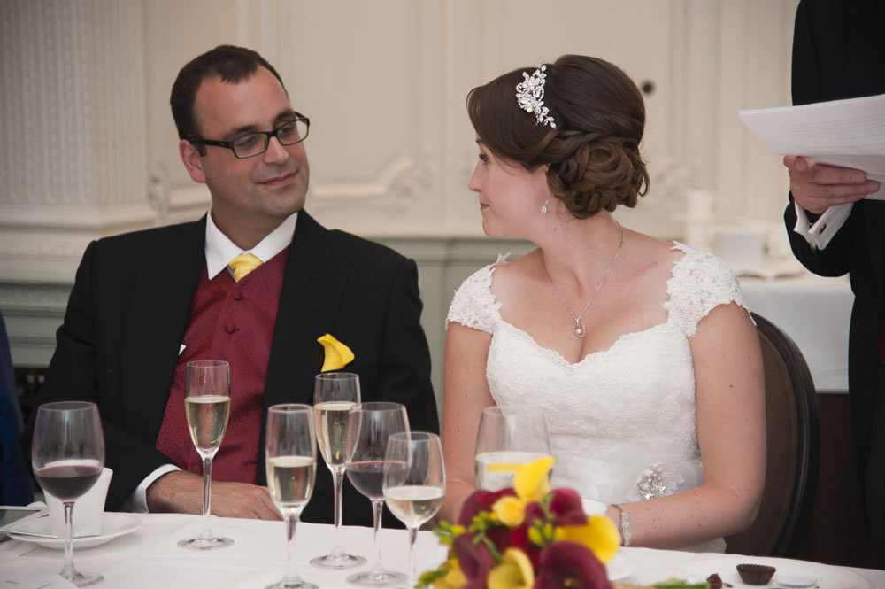 Bride and groom looking at each other during the speeches