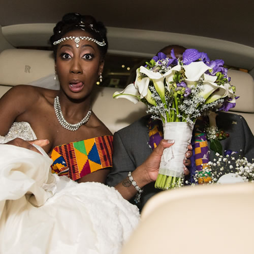 Bride covering groom's face with bouquet